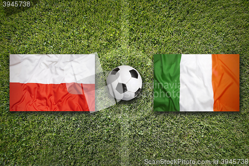 Image of Poland vs. Ireland flags on soccer field