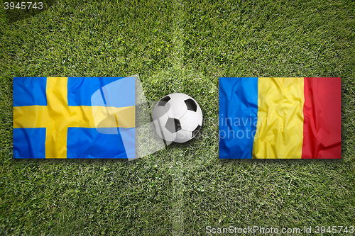 Image of Sweden vs. Romania flags on soccer field