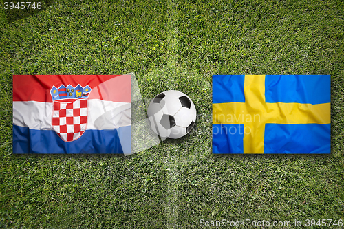 Image of Croatia vs. Sweden flags on soccer field