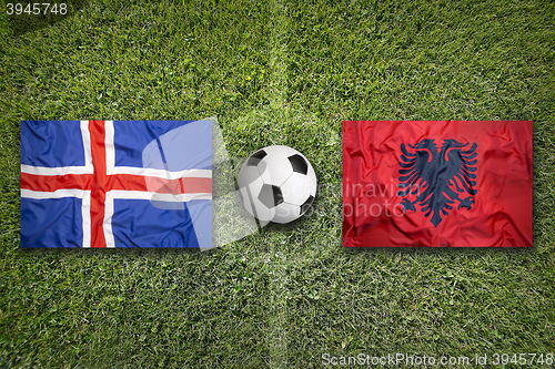 Image of Iceland vs. Albania flags on soccer field