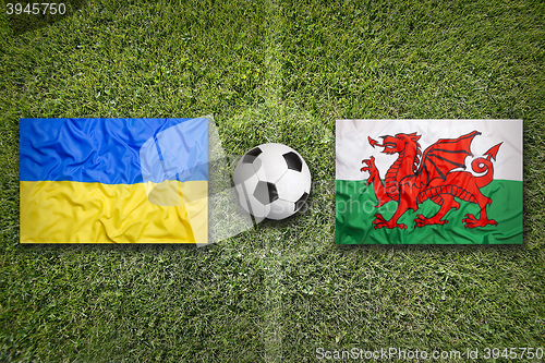 Image of Ukraine vs. Wales flags on soccer field