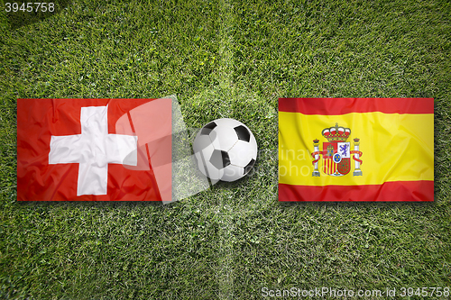 Image of Switzerland vs. Spain flags on soccer field