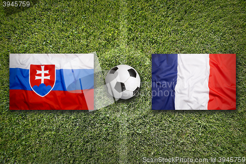 Image of Slovakia vs. France flags on soccer field