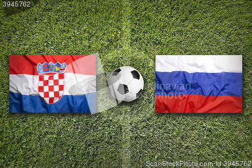 Image of Croatia vs. Russia flags on soccer field