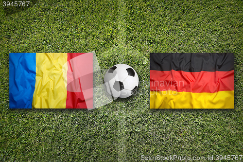 Image of Romania vs. Germany flags on soccer field