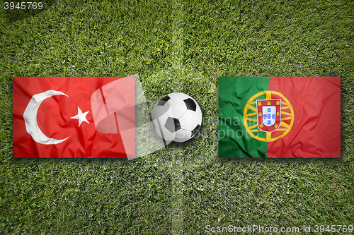 Image of Turkey vs. Portugal flags on soccer field