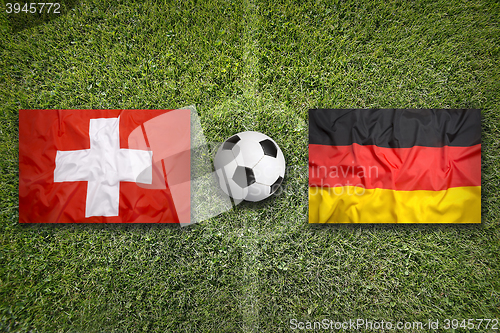 Image of Switzerland vs. Germany flags on soccer field