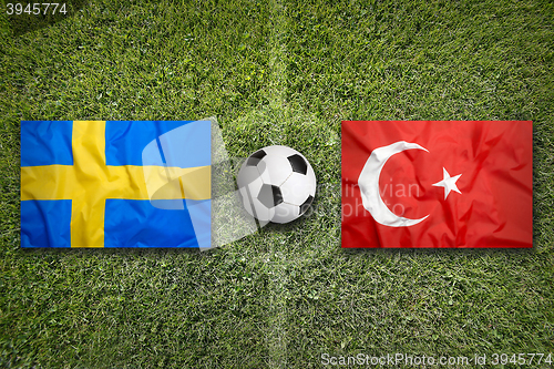Image of Sweden vs. Turkey flags on soccer field