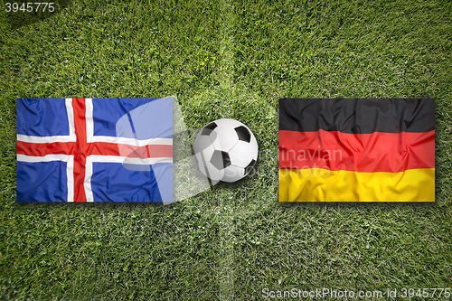 Image of Iceland vs. Germany flags on soccer field