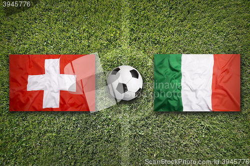 Image of Switzerland vs. Italy flags on soccer field
