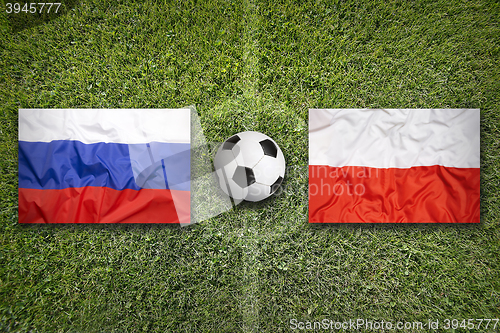 Image of Russia vs. Poland flags on soccer field
