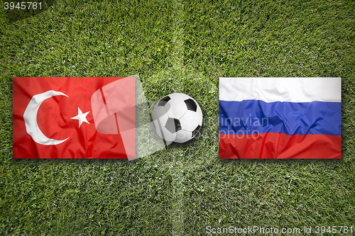 Image of Turkey vs. Russia flags on soccer field