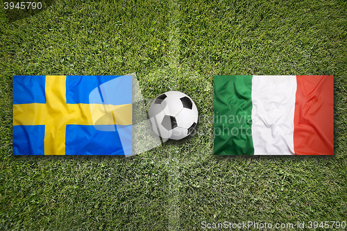 Image of Sweden vs. Italy flags on soccer field