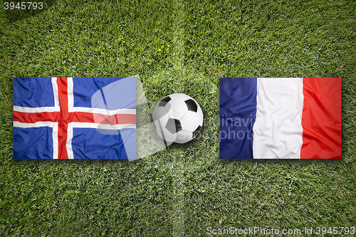 Image of Iceland vs. France flags on soccer field