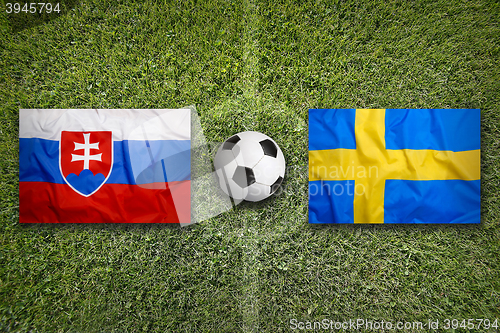 Image of Slovakia vs. Sweden flags on soccer field