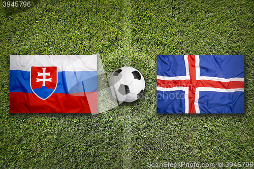 Image of Slovakia vs. Iceland flags on soccer field