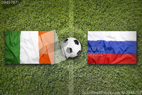 Image of Ireland vs. Russia flags on soccer field