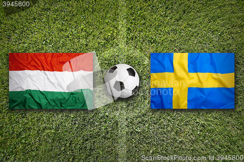 Image of Hungary vs. Sweden flags on soccer field