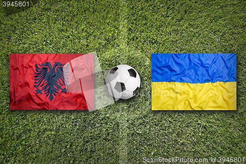 Image of Albania vs. Ukraine flags on soccer field