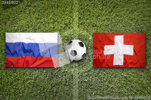 Image of Russia vs. Switzerland flags on soccer field