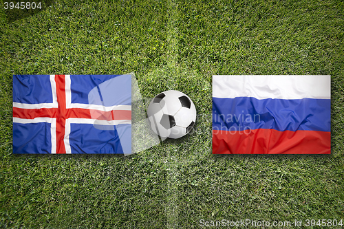 Image of Iceland vs. Russia flags on soccer field