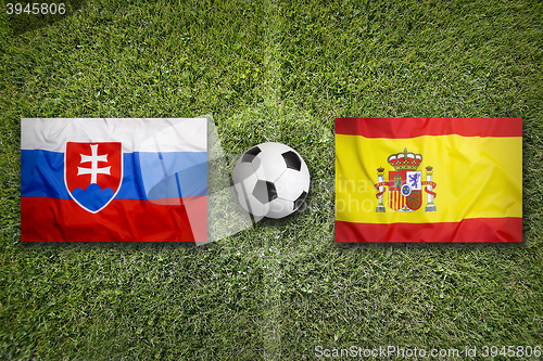 Image of Slovakia vs. Spain flags on soccer field