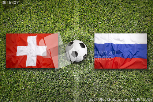 Image of Switzerland vs. Russia flags on soccer field