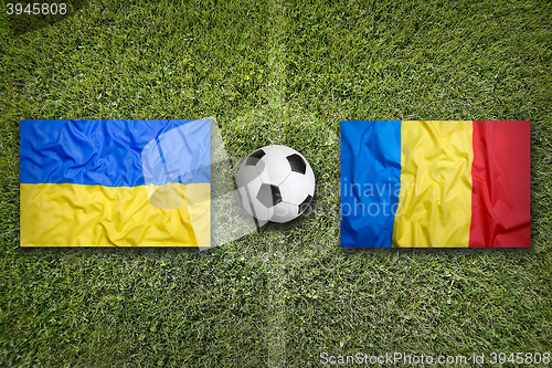 Image of Ukraine vs. Romania flags on soccer field