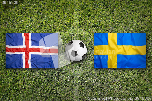 Image of Iceland vs. Sweden flags on soccer field