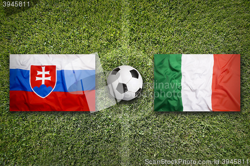 Image of Slovakia vs. Italy flags on soccer field