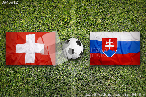 Image of Switzerland vs. Slovakia flags on soccer field