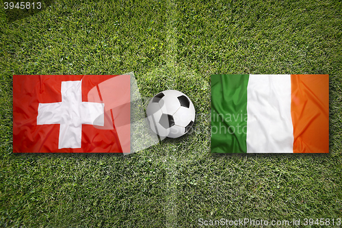 Image of Switzerland vs. Ireland flags on soccer field