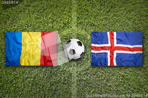 Image of Romania vs. Iceland flags on soccer field