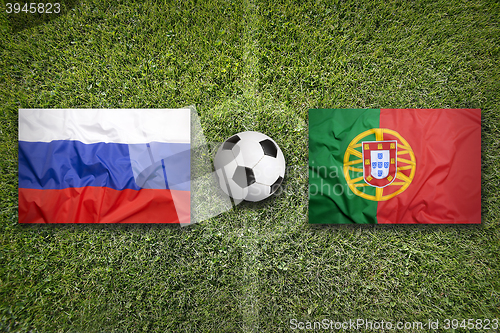 Image of Russia vs. Portugal flags on soccer field