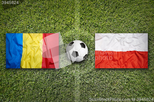 Image of Romania vs. Poland flags on soccer field