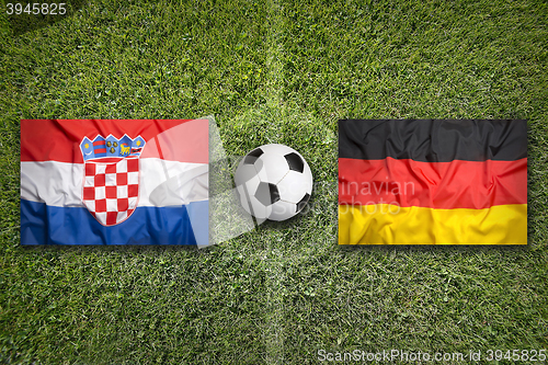 Image of Croatia vs. Germany flags on soccer field