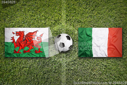 Image of Wales vs. Italy flags on soccer field