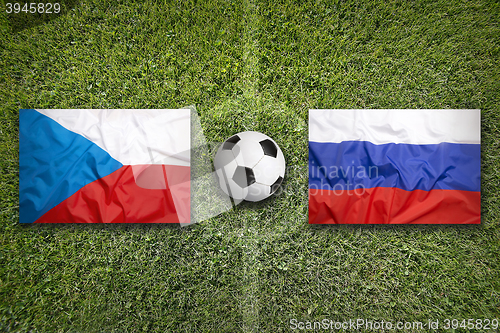 Image of Czech Republic vs. Russia flags on soccer field