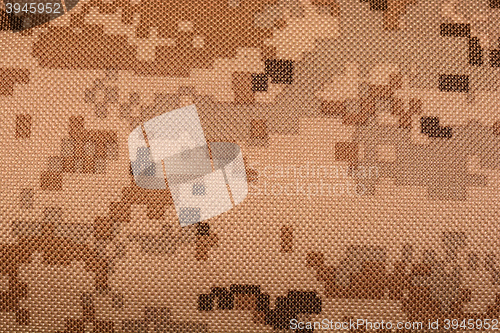 Image of close up of worn out olive green tone camouflage fabric