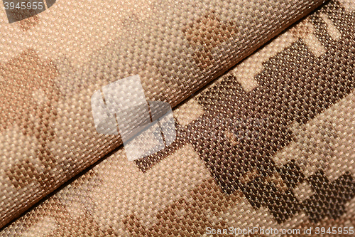 Image of close up of worn out olive green tone camouflage fabric