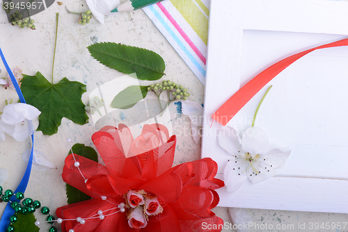 Image of Happy Valentine Day card with paper heart on table. Red hearts, flower, gift, pencil on table