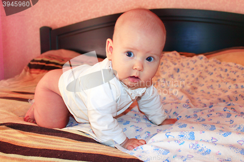 Image of little baby lying on the bed