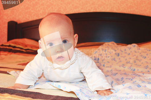 Image of little baby lying on the bed