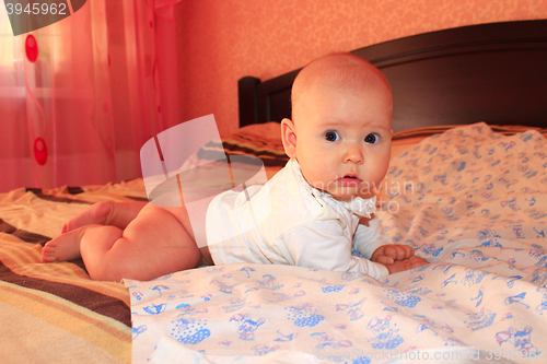 Image of little baby lying on the bed