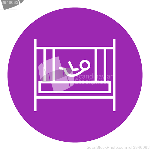 Image of Baby laying in crib line icon.