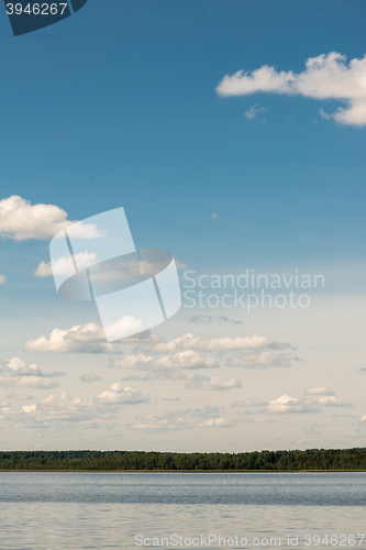 Image of Beautiful summer lake, on  background of forest and cloudy sky