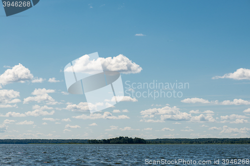 Image of Beautiful summer lake, on  background of forest and cloudy sky