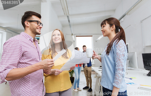 Image of creative team on coffee break talking at office