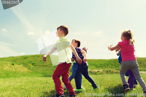 Image of group of happy kids running outdoors