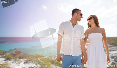 Image of happy smiling couple over summer beach and sea